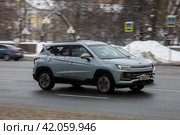 Car JAC JS4 driving fast on city street with blurred background. Moskvitch 3 crossover in motion on winter motorway. Редакционное фото, фотограф Константин Григорьев / Фотобанк Лори