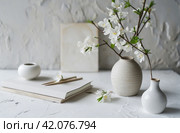 white paper template and pictures of white apsara flowers on a white table. Стоковое AI-изображение, AI-художник Юлия Гапеенко / Фотобанк Лори