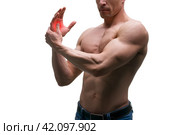 Pain in hand, carpal tunnel syndrome, muscular male body, studio isolated shot on white background. Стоковое фото, фотограф Станислав Тарко / Фотобанк Лори
