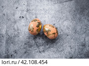 Stylish Peach Fuzz Easter eggs with a coating of golden sweat on a gray background. The concept of happy Easter 2024. Стоковое фото, фотограф Photojuli / Фотобанк Лори