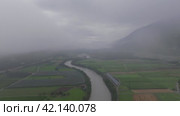 Aerial motion from right to left over river entering fog in Dolomites Austria. Стоковое видео, видеограф Данил Руденко / Фотобанк Лори