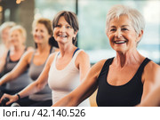 Active Senior Women Participating in Fitness Training and Smiling Together in Gym Workout Class. Стоковое AI-изображение, AI-художник Оксана Гильман / Фотобанк Лори