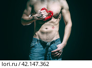 happy valentines day athletic man holds decorative red heart. Стоковое фото, фотограф Артем Курутин / Фотобанк Лори
