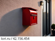 Red wooden Mailbox in an house residential building outside. Modern numbered mailboxes box outdoors, creative design mail backgrounds. Urban correspondence concept. Copy ad text space. Generated Ai. Стоковое AI-изображение, AI-художник Aleksandr Golubev / Фотобанк Лори