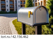 Silver wooden Mailbox in an house residential building outside. Modern numbered mailboxes box outdoors, creative design mail backgrounds. Urban correspondence concept. Copy ad text space. Generated Ai. Стоковое AI-изображение, AI-художник Aleksandr Golubev / Фотобанк Лори