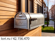 Silver wooden Mailbox in an house residential building outside. Modern numbered mailboxes box outdoors, creative design mail backgrounds. Urban correspondence concept. Copy ad text space. Generated Ai. Стоковое AI-изображение, AI-художник Aleksandr Golubev / Фотобанк Лори