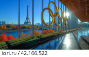 The Olympic rings and the Eiffel tower. Summer Olympic games concept. Стоковое AI-изображение, AI-художник Ирина Михайличенко / Фотобанк Лори