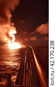 Fire on an offshore oil tanker. Стоковое AI-изображение, AI-художник Кирилл Черезов / Фотобанк Лори