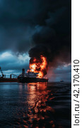 Fire on an offshore oil tanker. Стоковое AI-изображение, AI-художник Кирилл Черезов / Фотобанк Лори