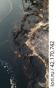 Oil spill on the surface of the reservoir. Стоковое AI-изображение, AI-художник Кирилл Черезов / Фотобанк Лори