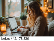 Image of happy woman using laptop while sitting at cafe with a window in the background. Young american woman sitting in a coffee shop and working on laptop. Стоковое AI-изображение, AI-художник Ирина Михайличенко / Фотобанк Лори