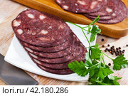 black puddingon served with parley on plate on wooden table. Стоковое фото, фотограф Яков Филимонов / Фотобанк Лори