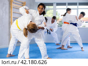 African american teenage girl practicing martial arts fighting techniques in sparring. Стоковое фото, фотограф Яков Филимонов / Фотобанк Лори