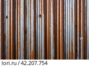 Old industrial corrugated iron industrial texture wall made of tin sheets. Grunge metal plate background. Copy ad text space. Стоковое AI-изображение, AI-художник Aleksandr Golubev / Фотобанк Лори