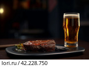 Cold beer grilled beef food. Generate Ai. Стоковое AI-изображение, AI-художник Иван Рябоконь / Фотобанк Лори