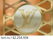 LILLE, FRANCE - FEBRUARY 21, 2024 : Golden logo sign of Louis Vuitton LV shop. Редакционное фото, фотограф Irina Kuchugurina/Gaudy / Фотобанк Лори
