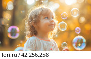 A toddler's giggle as they pop soap bubbles, the epitome of simple childhood joys. Стоковое AI-изображение, AI-художник Юлия Гапеенко / Фотобанк Лори