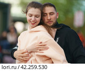 Moscow, Russia - May 9, 2022: Cheerful Dancing couple of young man and woman in public park. Lifestyle theme. Having fun people. People celevrate Victory Day, the win in the Great Patriotic War. Редакционное фото, фотограф YuryKara / Фотобанк Лори