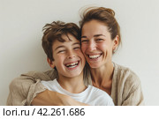 A woman and a boy smile and hug, sharing a happy gesture for the camera. Стоковое AI-изображение, AI-художник Юрий Поздников / Фотобанк Лори