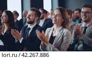 Business people applaud, celebrating a successful presentation. Teamwork and achievements fill the hall with positive energy. Стоковое AI-изображение, AI-художник Ярославский Максим / Фотобанк Лори