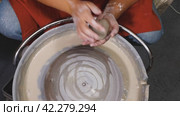 Top view of a woman's hands kneading a lump of white clay. Preparing the clay for work on the potter's wheel. Close-up. The concept of handicraft, art and craft. Стоковое видео, видеограф Воловодов Владимир / Фотобанк Лори