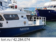 BAIKAL LAKE, SAKHYURTA VILLAGE, IRKUTSK REGION, RUSSIA - August 14, 2023: The regional fisheries protection ship at the pier on the shore of the Small Sea on a sunny summer day. Редакционное фото, фотограф Виктория Катьянова / Фотобанк Лори