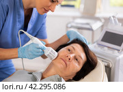 Mature woman receiving hardware facial procedure using cooling attachment. Стоковое фото, фотограф Яков Филимонов / Фотобанк Лори