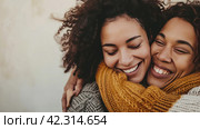 Two women in sweaters hug each other, care,Generative AI. Стоковое AI-изображение, AI-художник Анна Кривицкая / Фотобанк Лори