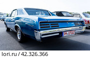 LINTHE, GERMANY - MAY 27, 2023: The muscle car Pontiac GTO, (first generation). Rear view. Die Oldtimer Show 2023. Редакционное фото, фотограф Sergey Kohl / Фотобанк Лори