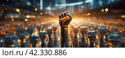 Illuminated robotic fist raised against a backdrop of numerous androids. Symbol of AI revolution. Mechanical hand upraised in a defiant gesture amidst a crowd. Panorama with copy space. Стоковое AI-изображение, AI-художник Igor Tichonow / Фотобанк Лори