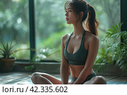 Side view of Asian woman wearing green sportwear doing Yoga exercise. Calm of healthy young woman breathing and meditation with yoga at home. Стоковое AI-изображение, AI-художник Ирина Михайличенко / Фотобанк Лори