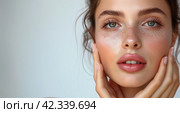 Close up portrait young beautiful woman touch her perfect smooth skin on grey studio background. Sensuality, natural beauty, plastic surgery, aesthetic medicine, cosmetology, cosmetics, skin care. Стоковое AI-изображение, AI-художник Alexander Tihonovs / Фотобанк Лори