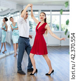 Couple in stage costumes learns boogie woogie dancing during individual lesson. Стоковое фото, фотограф Яков Филимонов / Фотобанк Лори