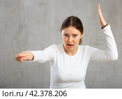 Indignant adult woman girl gesturing in studio. Стоковое фото, фотограф Яков Филимонов / Фотобанк Лори