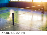 Top view of volleyball court with net in school gym. Backdrop sports image of volleyball courts in sport hall. Concept of team game, active match, healthy lifestyle, team success. Copy ad text space. Стоковое фото, фотограф Aleksandr Golubev / Фотобанк Лори