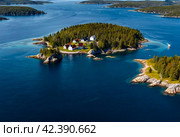 Aerial landscape of archipelago of islands with buildings and houses in Baltic Sea near city of Stockholm with blue sky. Background of amazing natural scenery view of Scandinavian nature. Copy space. Стоковое AI-изображение, AI-художник Aleksandr Golubev / Фотобанк Лори