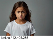 Portrait of frowning cover girl kid model 6 year old in white t-shirt expression emotion, angry looking at camera. Scowl child posing at black, studio shot. Kids emotional concept. Copy ad text space. Стоковое AI-изображение, AI-художник Aleksandr Golubev / Фотобанк Лори