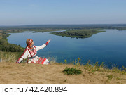Kozlovsky district,Chuvashia/Russian Federation - 08.17.2022 - a woman in Chuvash national dress at the tourist site "Bird Flight" Редакционное фото, фотограф Андриян Григорьевич Чаркин / Фотобанк Лори