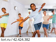 Smiling african american preteen boy practicing vigorous dance. Стоковое фото, фотограф Яков Филимонов / Фотобанк Лори