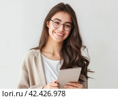 Smiling Young Woman with Tablet. Стоковое AI-изображение, AI-художник Кирилл Черезов / Фотобанк Лори