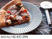 Slices of pizza with cheese with bell pepper and meat on a plate. Стоковое фото, фотограф Светлана Высокос / Фотобанк Лори