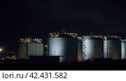 Huge oil refinery tank at night, ominous, detailed, dark, dim lighting, glowy, sinister ,    Generative AI. Стоковое AI-изображение, AI-художник Анна Кривицкая / Фотобанк Лори