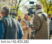 Senior Man Being Interviewed on Camera. Стоковое AI-изображение, AI-художник Кирилл Черезов / Фотобанк Лори