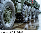 Military Convoy on Standby. Стоковое AI-изображение, AI-художник Кирилл Черезов / Фотобанк Лори