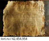 Old parchment paper with illegible writing on it,    Generative AI. Стоковое AI-изображение, AI-художник Анна Кривицкая / Фотобанк Лори