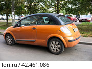 Citroen C3 Pluriel in orange color parked on the street. Pluriel can be configured as a hatchback with a multi-layer insulated top. Old convertible car produced by PSA Group. Редакционное фото, фотограф Константин Григорьев / Фотобанк Лори