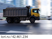 Scania P380 tipper truck is driving in city on high speed. Dump truck Scania with yellow cabin at the city highway in motion. Редакционное фото, фотограф Константин Григорьев / Фотобанк Лори
