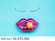Shining pink lips and ripe yellow cherry on bright blue background, makeup and beauty concept. Стоковое фото, фотограф Александра Баранова / Фотобанк Лори