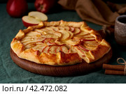 Apple pie, galette with fruits, sweet pastries on dark green tablecloth, close up, side view. Стоковое фото, фотограф Natalia Gdovskaia / Фотобанк Лори