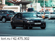 Car BMW 318i Ci coupe moving on city street, front side view. BMW 3 Series E46 in urban landscape. Редакционное фото, фотограф Константин Григорьев / Фотобанк Лори